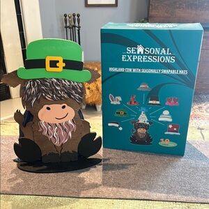 Seasonal Expressions Highland cow with seasonal swappable hats 10 different hats